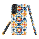 The Mediterranean Bloom for Samsung by Statement Cases features intricate, colorful floral patterns in blue, orange, and yellow. The design covers the entire back of the case, surrounding the camera cutout. Shock-absorbing and impact-resistant, it ensures protection while the brand "Statement Cases" is subtly printed near the bottom.