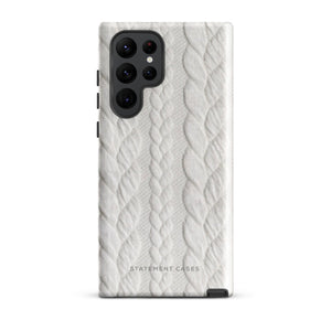 A stylish, impact-resistant phone case with a textured white braided design, covering the back of a smartphone. The dual-layer design features cutouts for the camera and buttons, and "Cozy Knit Bliss for Samsung" by Statement Cases is embossed at the bottom.