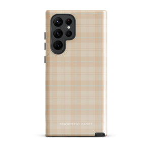 A smartphone with an impact-resistant beige plaid phone case featuring subtle light blue accents. The camera, flash, and sensor modules are visible at the top. The bottom part of the case has the text "Sophisticated Plaid for Samsung" printed on it by Statement Cases.