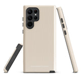 A beige smartphone case with vertical stripes designed for a phone with a triple camera setup. This impact-resistant phone case features precise cutouts for the cameras, buttons, and other essential functions. "Statement Cases" is printed at the bottom of the tough phone case. Product Name: Noble Pinstripe for Samsung