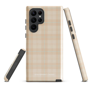 A smartphone with an impact-resistant beige plaid phone case featuring subtle light blue accents. The camera, flash, and sensor modules are visible at the top. The bottom part of the case has the text "Sophisticated Plaid for Samsung" printed on it by Statement Cases.