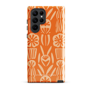 This stylish smartphone accessory, the Savannah Ardiente for Samsung by Statement Cases, features a shock-absorbing, colorful patterned case adorned with abstract flower designs in beige on an orange background. This impact-resistant phone case wraps around the back of your device, providing robust protection for its multiple camera lenses in the corner.