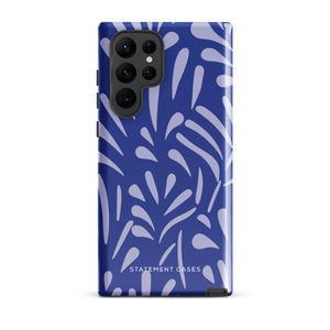 The Mariposa Azul for Samsung smartphone case from Statement Cases is adorned with an impact-resistant design featuring light purple abstract shapes on a blue background. This dual-layer case proudly displays the text "STATEMENT CASES" at the bottom, ensuring that the camera lenses and buttons of your phone remain clearly visible.