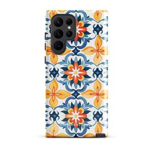 The Mediterranean Bloom for Samsung by Statement Cases features intricate, colorful floral patterns in blue, orange, and yellow. The design covers the entire back of the case, surrounding the camera cutout. Shock-absorbing and impact-resistant, it ensures protection while the brand "Statement Cases" is subtly printed near the bottom.