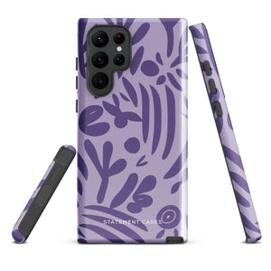 Introducing the Luna Morada for Samsung, a striking smartphone case from Statement Cases. This decorative purple cover boasts abstract floral and organic patterns in darker hues and is designed to absorb shocks. The impact-resistant case features a camera cutout that accommodates five lenses, with the brand name "STATEMENT CASES" elegantly printed at the bottom center.