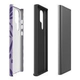 Introducing the Luna Morada for Samsung, a striking smartphone case from Statement Cases. This decorative purple cover boasts abstract floral and organic patterns in darker hues and is designed to absorb shocks. The impact-resistant case features a camera cutout that accommodates five lenses, with the brand name "STATEMENT CASES" elegantly printed at the bottom center.