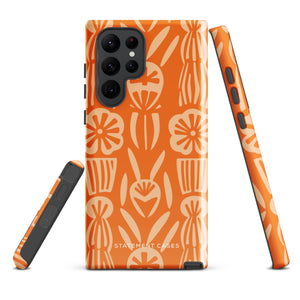 This stylish smartphone accessory, the Savannah Ardiente for Samsung by Statement Cases, features a shock-absorbing, colorful patterned case adorned with abstract flower designs in beige on an orange background. This impact-resistant phone case wraps around the back of your device, providing robust protection for its multiple camera lenses in the corner.