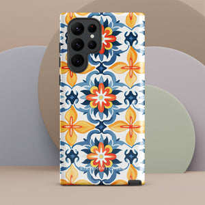 The Mediterranean Bloom for Samsung by Statement Cases features intricate, colorful floral patterns in blue, orange, and yellow. The design covers the entire back of the case, surrounding the camera cutout. Shock-absorbing and impact-resistant, it ensures protection while the brand "Statement Cases" is subtly printed near the bottom.