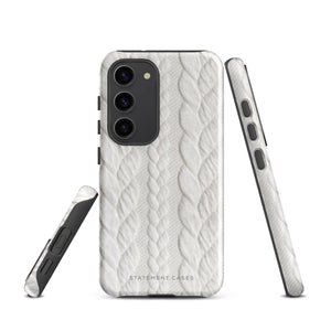 A stylish, impact-resistant phone case with a textured white braided design, covering the back of a smartphone. The dual-layer design features cutouts for the camera and buttons, and "Cozy Knit Bliss for Samsung" by Statement Cases is embossed at the bottom.