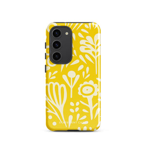 The Sol Dorado for Samsung by Statement Cases is a durable phone case featuring a bright yellow background adorned with an abstract white floral pattern, showcasing various flowers and leaves. Near the bottom edge, the text "STATEMENT CASE" highlights its dual-layer design for enhanced durability.