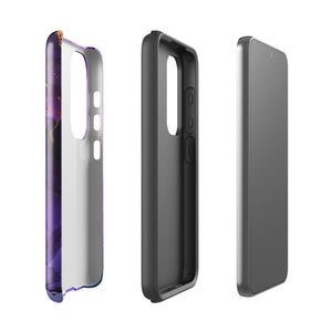 The Golden Orchid Marble for Samsung by Statement Cases is a smartphone adorned with a vibrant, abstract phone case showcasing a mix of purple, pink, and gold colors. Crafted from impact-resistant materials, it features a camera module with four lenses and a flash. At the bottom of the shock-absorbing phone case, you’ll find the text "STATEMENT CASES" in white.