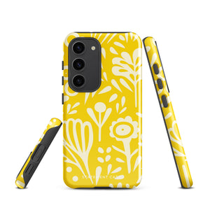 The Sol Dorado for Samsung by Statement Cases is a durable phone case featuring a bright yellow background adorned with an abstract white floral pattern, showcasing various flowers and leaves. Near the bottom edge, the text "STATEMENT CASE" highlights its dual-layer design for enhanced durability.