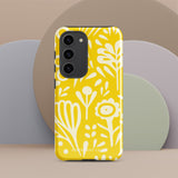 The Sol Dorado for Samsung by Statement Cases is a durable phone case featuring a bright yellow background adorned with an abstract white floral pattern, showcasing various flowers and leaves. Near the bottom edge, the text "STATEMENT CASE" highlights its dual-layer design for enhanced durability.