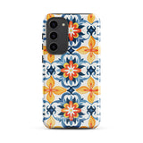 The Mediterranean Bloom for Samsung by Statement Cases features intricate, colorful floral patterns in blue, orange, and yellow. The design covers the entire back of the case, surrounding the camera cutout. Shock-absorbing and impact-resistant, it ensures protection while the brand "Statement Cases" is subtly printed near the bottom.