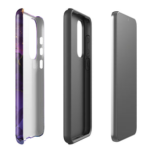 The Golden Orchid Marble for Samsung by Statement Cases is a smartphone adorned with a vibrant, abstract phone case showcasing a mix of purple, pink, and gold colors. Crafted from impact-resistant materials, it features a camera module with four lenses and a flash. At the bottom of the shock-absorbing phone case, you’ll find the text "STATEMENT CASES" in white.