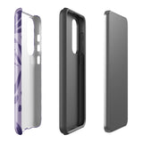 Introducing the Luna Morada for Samsung, a striking smartphone case from Statement Cases. This decorative purple cover boasts abstract floral and organic patterns in darker hues and is designed to absorb shocks. The impact-resistant case features a camera cutout that accommodates five lenses, with the brand name "STATEMENT CASES" elegantly printed at the bottom center.