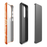 This stylish smartphone accessory, the Savannah Ardiente for Samsung by Statement Cases, features a shock-absorbing, colorful patterned case adorned with abstract flower designs in beige on an orange background. This impact-resistant phone case wraps around the back of your device, providing robust protection for its multiple camera lenses in the corner.