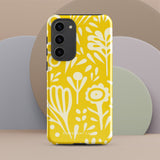 The Sol Dorado for Samsung by Statement Cases is a durable phone case featuring a bright yellow background adorned with an abstract white floral pattern, showcasing various flowers and leaves. Near the bottom edge, the text "STATEMENT CASE" highlights its dual-layer design for enhanced durability.