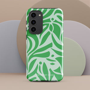 The Selva Verde for Samsung, a product by Statement Cases, is a durable, dual-layer phone case adorned with a green and white leafy design. The back of the case includes a camera cutout, and the bottom is printed with "Statement Cases.