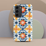 The Mediterranean Bloom for Samsung by Statement Cases features intricate, colorful floral patterns in blue, orange, and yellow. The design covers the entire back of the case, surrounding the camera cutout. Shock-absorbing and impact-resistant, it ensures protection while the brand "Statement Cases" is subtly printed near the bottom.