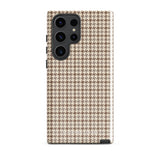 A Samsung smartphone with a beige and brown houndstooth patterned, impact-resistant case from Statement Cases. The phone features multiple cameras on the upper left side of its back. This tough Classic Houndstooth for Samsung phone case has a sleek, dual-layer design with precise cutouts for the cameras and buttons.