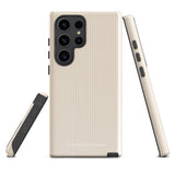 A beige smartphone case with vertical stripes designed for a phone with a triple camera setup. This impact-resistant phone case features precise cutouts for the cameras, buttons, and other essential functions. "Statement Cases" is printed at the bottom of the tough phone case. Product Name: Noble Pinstripe for Samsung