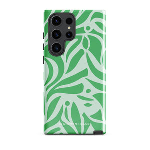 The Selva Verde for Samsung, a product by Statement Cases, is a durable, dual-layer phone case adorned with a green and white leafy design. The back of the case includes a camera cutout, and the bottom is printed with "Statement Cases.