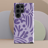 Introducing the Luna Morada for Samsung, a striking smartphone case from Statement Cases. This decorative purple cover boasts abstract floral and organic patterns in darker hues and is designed to absorb shocks. The impact-resistant case features a camera cutout that accommodates five lenses, with the brand name "STATEMENT CASES" elegantly printed at the bottom center.