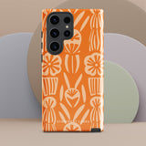 This stylish smartphone accessory, the Savannah Ardiente for Samsung by Statement Cases, features a shock-absorbing, colorful patterned case adorned with abstract flower designs in beige on an orange background. This impact-resistant phone case wraps around the back of your device, providing robust protection for its multiple camera lenses in the corner.