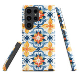 The Mediterranean Bloom for Samsung by Statement Cases features intricate, colorful floral patterns in blue, orange, and yellow. The design covers the entire back of the case, surrounding the camera cutout. Shock-absorbing and impact-resistant, it ensures protection while the brand "Statement Cases" is subtly printed near the bottom.