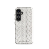 A stylish, impact-resistant phone case with a textured white braided design, covering the back of a smartphone. The dual-layer design features cutouts for the camera and buttons, and "Cozy Knit Bliss for Samsung" by Statement Cases is embossed at the bottom.