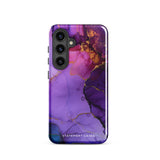 The Golden Orchid Marble for Samsung by Statement Cases is a smartphone adorned with a vibrant, abstract phone case showcasing a mix of purple, pink, and gold colors. Crafted from impact-resistant materials, it features a camera module with four lenses and a flash. At the bottom of the shock-absorbing phone case, you’ll find the text "STATEMENT CASES" in white.