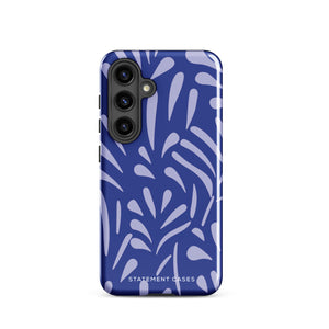 The Mariposa Azul for Samsung smartphone case from Statement Cases is adorned with an impact-resistant design featuring light purple abstract shapes on a blue background. This dual-layer case proudly displays the text "STATEMENT CASES" at the bottom, ensuring that the camera lenses and buttons of your phone remain clearly visible.