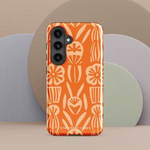 This stylish smartphone accessory, the Savannah Ardiente for Samsung by Statement Cases, features a shock-absorbing, colorful patterned case adorned with abstract flower designs in beige on an orange background. This impact-resistant phone case wraps around the back of your device, providing robust protection for its multiple camera lenses in the corner.