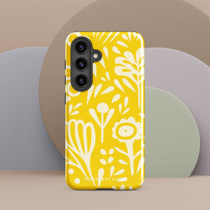 The Sol Dorado for Samsung by Statement Cases is a durable phone case featuring a bright yellow background adorned with an abstract white floral pattern, showcasing various flowers and leaves. Near the bottom edge, the text "STATEMENT CASE" highlights its dual-layer design for enhanced durability.