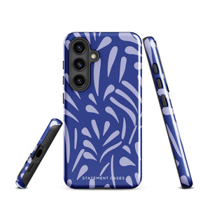 The Mariposa Azul for Samsung smartphone case from Statement Cases is adorned with an impact-resistant design featuring light purple abstract shapes on a blue background. This dual-layer case proudly displays the text "STATEMENT CASES" at the bottom, ensuring that the camera lenses and buttons of your phone remain clearly visible.