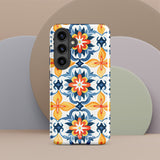 The Mediterranean Bloom for Samsung by Statement Cases features intricate, colorful floral patterns in blue, orange, and yellow. The design covers the entire back of the case, surrounding the camera cutout. Shock-absorbing and impact-resistant, it ensures protection while the brand "Statement Cases" is subtly printed near the bottom.