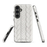 A stylish, impact-resistant phone case with a textured white braided design, covering the back of a smartphone. The dual-layer design features cutouts for the camera and buttons, and "Cozy Knit Bliss for Samsung" by Statement Cases is embossed at the bottom.