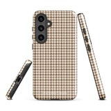 A Samsung smartphone with a beige and brown houndstooth patterned, impact-resistant case from Statement Cases. The phone features multiple cameras on the upper left side of its back. This tough Classic Houndstooth for Samsung phone case has a sleek, dual-layer design with precise cutouts for the cameras and buttons.