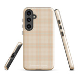 A smartphone with an impact-resistant beige plaid phone case featuring subtle light blue accents. The camera, flash, and sensor modules are visible at the top. The bottom part of the case has the text "Sophisticated Plaid for Samsung" printed on it by Statement Cases.