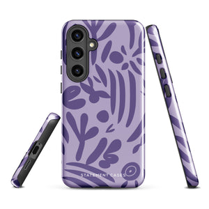 Introducing the Luna Morada for Samsung, a striking smartphone case from Statement Cases. This decorative purple cover boasts abstract floral and organic patterns in darker hues and is designed to absorb shocks. The impact-resistant case features a camera cutout that accommodates five lenses, with the brand name "STATEMENT CASES" elegantly printed at the bottom center.