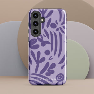 Introducing the Luna Morada for Samsung, a striking smartphone case from Statement Cases. This decorative purple cover boasts abstract floral and organic patterns in darker hues and is designed to absorb shocks. The impact-resistant case features a camera cutout that accommodates five lenses, with the brand name "STATEMENT CASES" elegantly printed at the bottom center.