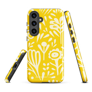 The Sol Dorado for Samsung by Statement Cases is a durable phone case featuring a bright yellow background adorned with an abstract white floral pattern, showcasing various flowers and leaves. Near the bottom edge, the text "STATEMENT CASE" highlights its dual-layer design for enhanced durability.