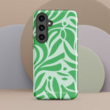 The Selva Verde for Samsung, a product by Statement Cases, is a durable, dual-layer phone case adorned with a green and white leafy design. The back of the case includes a camera cutout, and the bottom is printed with "Statement Cases.