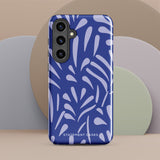 The Mariposa Azul for Samsung smartphone case from Statement Cases is adorned with an impact-resistant design featuring light purple abstract shapes on a blue background. This dual-layer case proudly displays the text "STATEMENT CASES" at the bottom, ensuring that the camera lenses and buttons of your phone remain clearly visible.