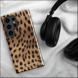 A smartphone with a leopard print, dual-layer design phone case featuring four camera lenses on the back is displayed against a white background. The bottom of the tough phone case has the brand name "Statement Cases" in white letters. The product name is "Daring Cheetah Fur for Samsung".