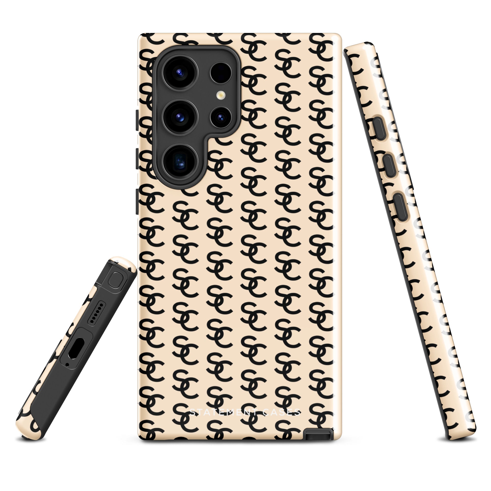 A beige smartphone case with a repeating black double-C logo pattern. The back of the impact-resistant phone case features camera cutouts aligned on the left side, accommodating what appears to be a multi-lens camera system. This is the Heritage Monogram for Samsung by Statement Cases.