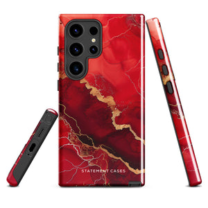 A red and black Scarlet Marble for Samsung with a marble-like pattern and gold accents, designed for a phone with multiple rear cameras. This tough phone case features an impact-resistant, dual-layer design and showcases the brand name "Statement Cases" near the bottom.