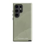 A Pistachio Haze for Samsung with a green phone case featuring a subtle floral pattern. This tough phone case has cutouts for three cameras and a flash, with the brand name "Statement Cases" printed at the bottom. The side buttons are visible, and there's a port at the bottom for easy access.