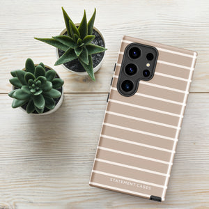 A smartphone with a tan and white striped, impact-resistant case labeled "Statement Cases Au Naturale for Samsung" lies on a wooden surface beside three small potted succulent plants.